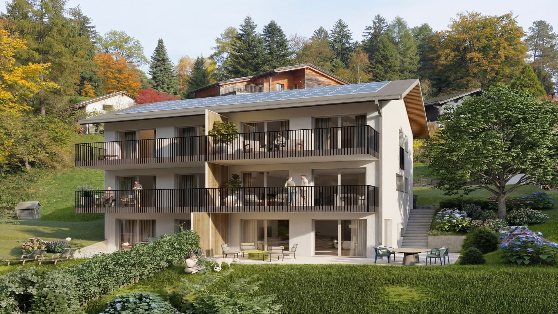 Immeuble résidentiel neuf de trois niveaux avec façades claires, détails en bois, grands balcons, baies vitrées, panneaux solaires en toiture et jardin arboré en pente.